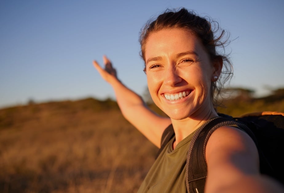 close-up of female college student with brown hair hiking outdoors